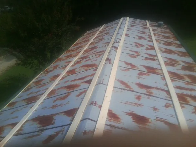 Rusted metal roof panels with new wood purlins before replacement — Storm Damage Roof Repair in Oracle by Roofing Brothers